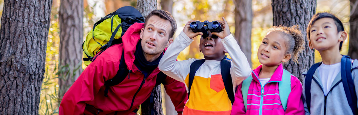 Teacher giving science lecture to elementary student