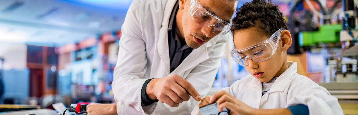 Teacher giving science lecture to elementary student